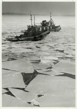 Fighting wind and snow and crackling harbor ice the tugs must go through