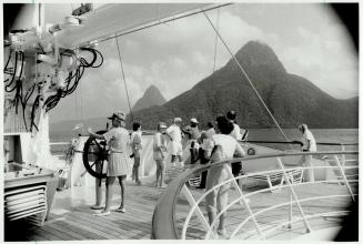 Passengers handle wheel of the tall ship from the time to time on computer-run cruise