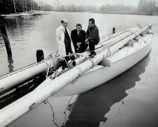 Talking over bad news abroad 12-metre yacht, Golden Eagle, are owners (left to right) Gerry Morris, Michael Pellegrin and Herb Wahl. Bought as trial h(...)