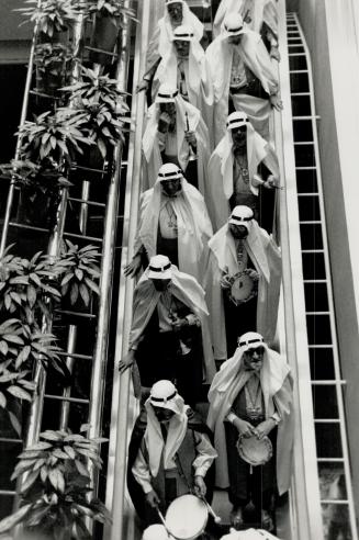 Two by two: As Shriners invade the Sheraton Centre for a closed initiation ceremony yesterday, the Hamilton Oriental Band takes over and escalator