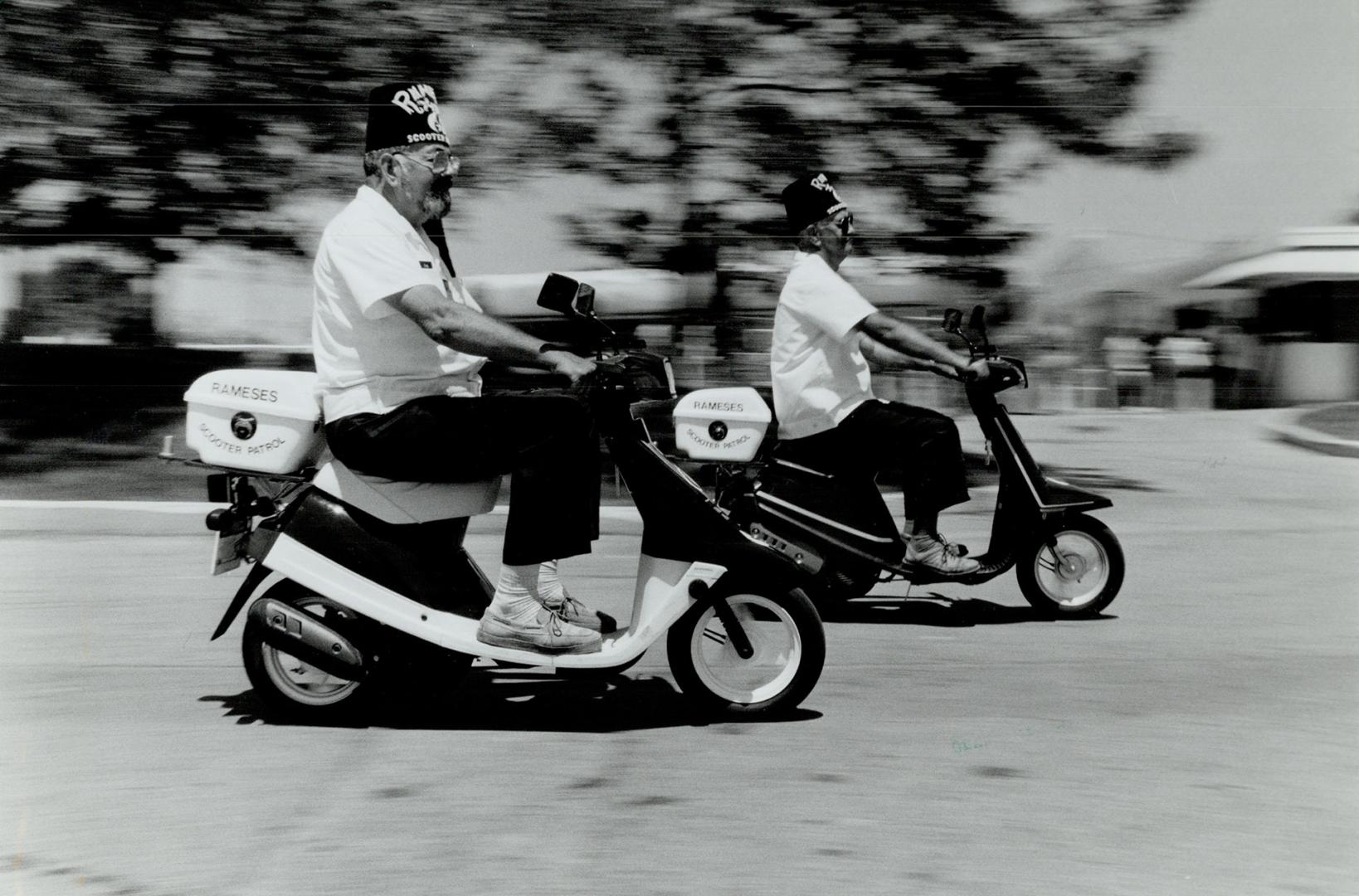 Who you gonna call? Bob Webster, 63, left, and Howard Clausen, 64, marshals at tomorrow's Shriners parade, show off their scooters at Ontario Place yesterday