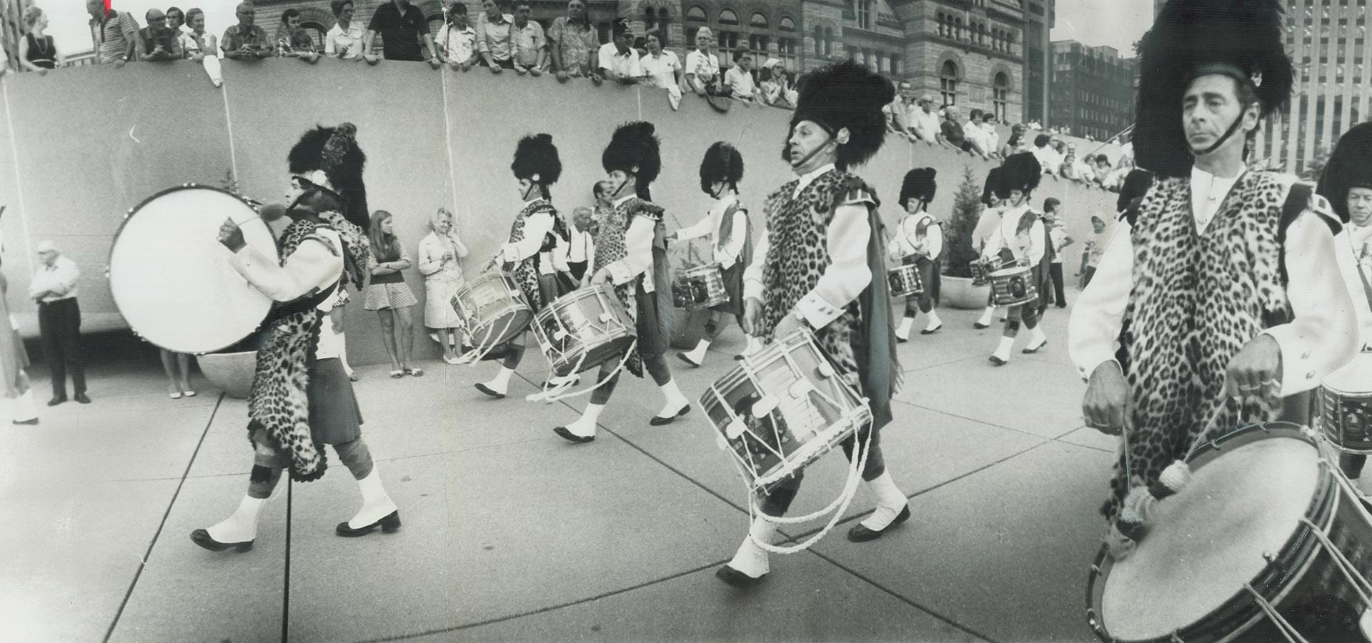 The pipe-and-drum band of the Toronto Scottish Regiment performs last night in Nathan Phillips Square, where massed bands of three other military units presented a Dominion Day concert