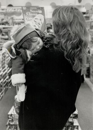 Just pooped: A worn out 10-month- old Shiona Middlemiss snoozes while her mother, Donna, shops in an Eaton Centre book store