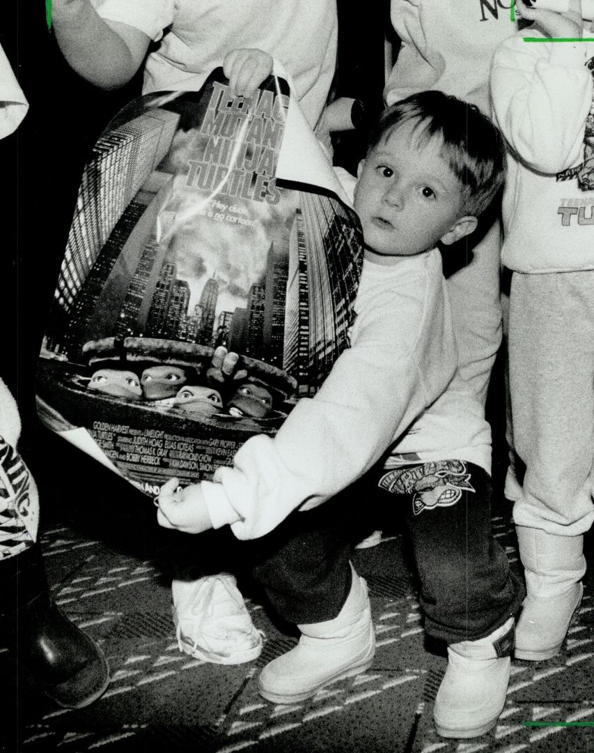 Image shows Carl Easson, 4, holding his souvenir poster all picked out yesterday at a Fairview …