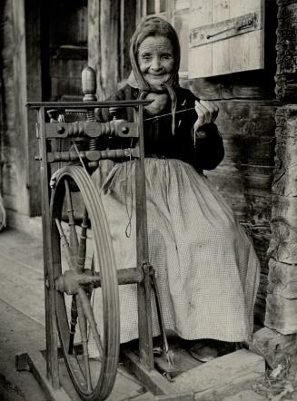 This old spinning wheel hasn't made the parlor grade yet, but is in regular use by an 83-year-old lady of Bernese Oberland, Switzerland