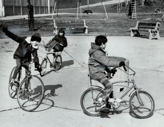 It's too late for tobogganing and too early for swimming so these youngsters on their winter break slalom on their bicycles in empty wading pool of ne(...)