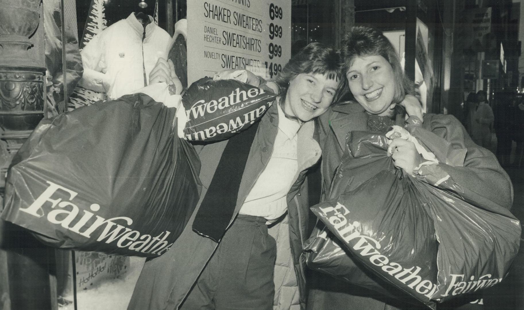 Bargain hunters: A happy Rhonda Watson, 15, from Bobcaygeon (left) and aunt Brenda Walker, 20, of Aurora stand outside a downtown store with $200 worth of Boxing Day bargains