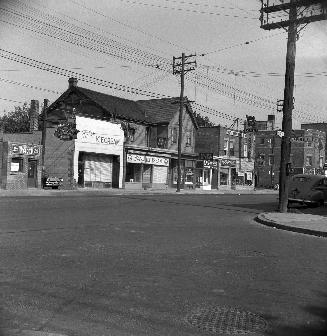 Store fronts and former Bedford Park Hotel, Yonge and Glenforest. Image shows a few stores. The…