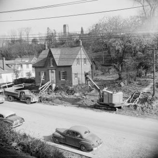 C.W. Jeffreys house, east side of Yonge Street, north of York Mills Road., being prepared for being moved. View looking northeast. Toronto, Ontario