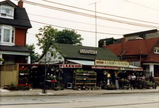 Image shows a Garden Centre along the street with a number of plants around it.