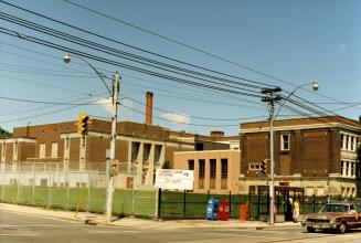 Image shows an intersection view with a construction site at the corner.