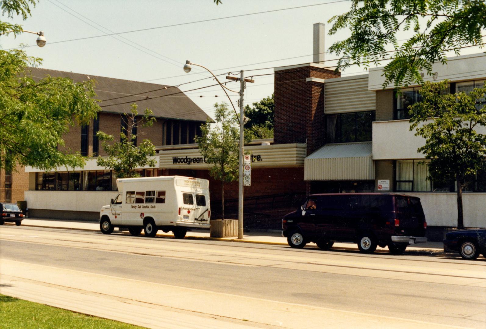 Image shows a partial view of the recreation centre facing the street. There are a few vehicles…