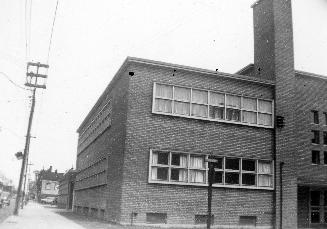 Image shows a partial view of a two storey building.