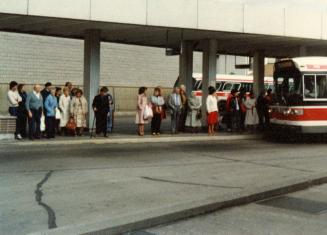 People waiting to get on bus at Pape Station