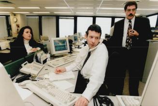 Mary Helen Morra, Kevin Dunseath, on phone, and Doug Carmichael of TD Green Line watch Bre-X plummet