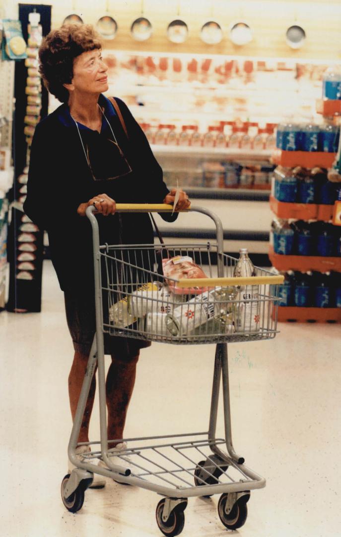 Wheely good: Customer Min Beardmore strolls around the Dominion store in Leaside with one of the half-size shopping carts, perfect for singles and seniors