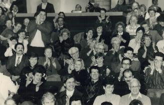 North York Mayor Mel Lastman appears glum late last night as a raucous crowd in the council chamber applauds one of many residents who spoke against Sunday shopping