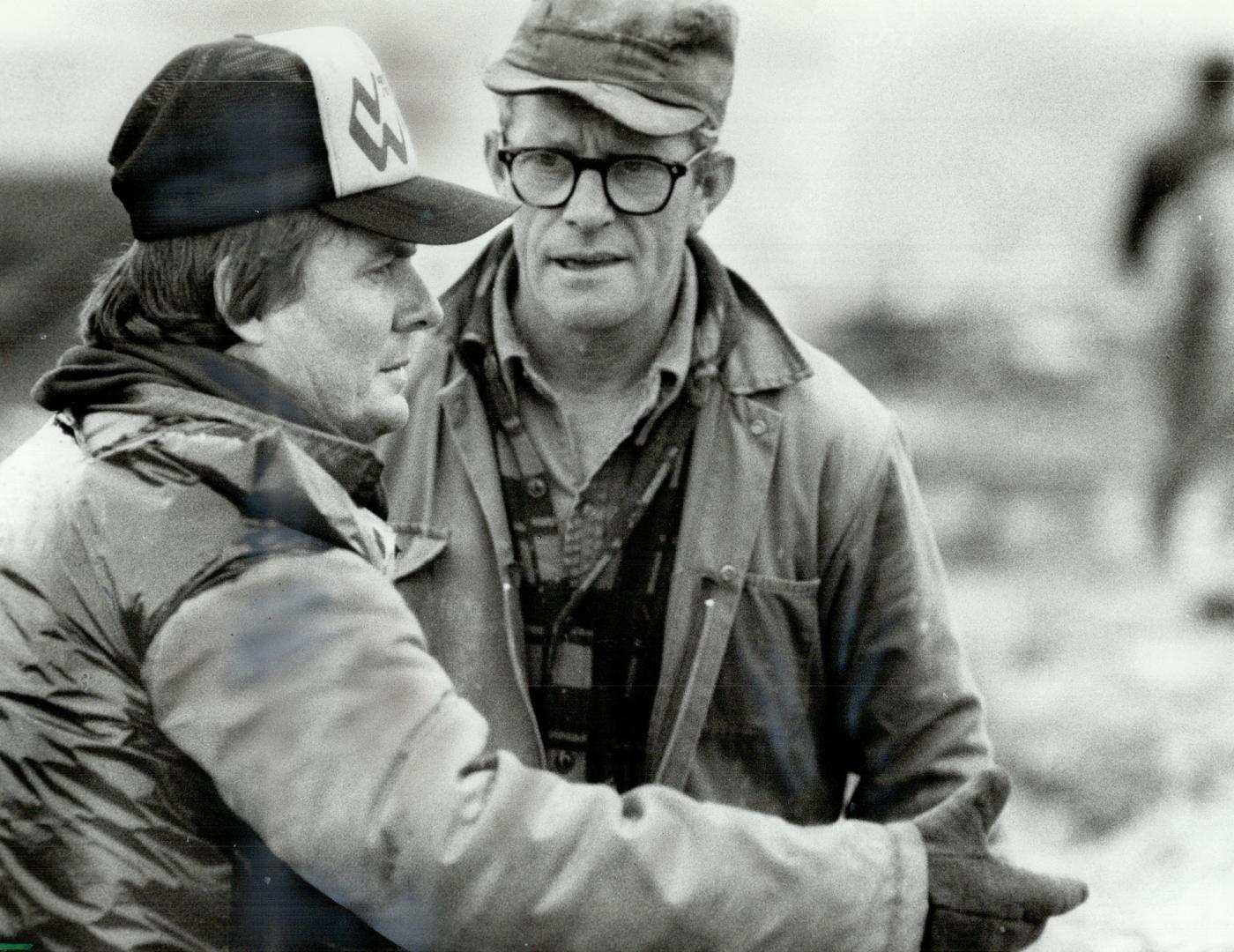 Storm victim: Bob Dobbin (left) ruminates with a farm helper over the vicious storm that wrecked his $200,000 farmhouse in Reeces Corners, and left a trail of destruction behind