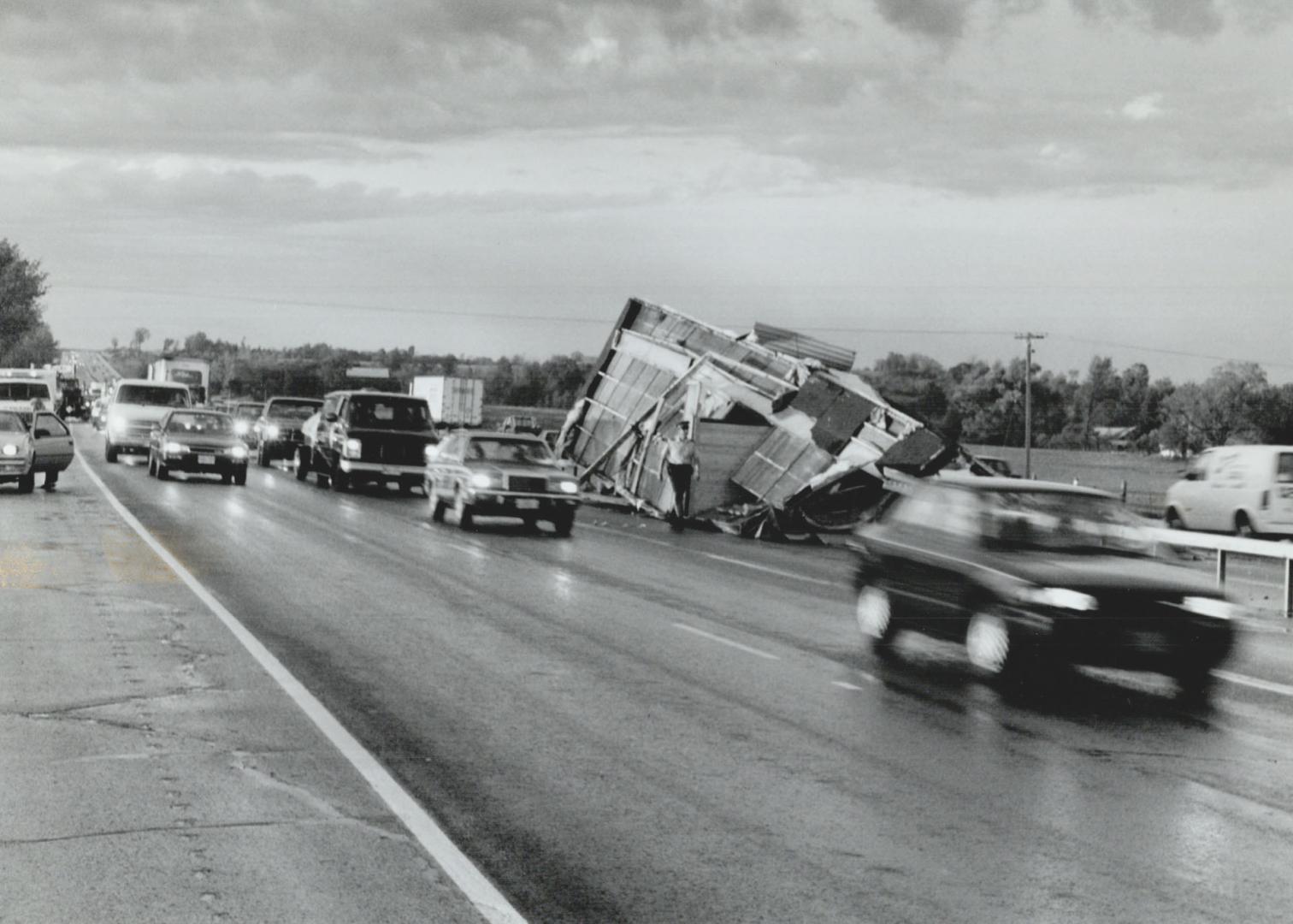 Storm's wake: Traffic crawls southbound on Highway 400 near Highway 89 last night past a mobile home, blown off a flatbed truck in a flash storm