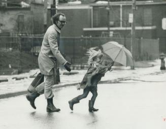 Tall Buildings downtown can increase wind velocity, as Cliff Whiten and daughter Megan discovered on a Toronto street