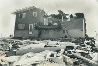 Smashed by the storm this Sudbury house had most of its roof ripped away by 100-mile-an-hour winds that swept through Nickel Belt area yesterday leavi(...)