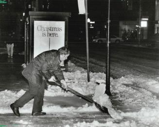 Digging out: Torontonians had to shovel and brush then clamber over treacherous snow banks to get to work today after last night's storm swept southern Ontario