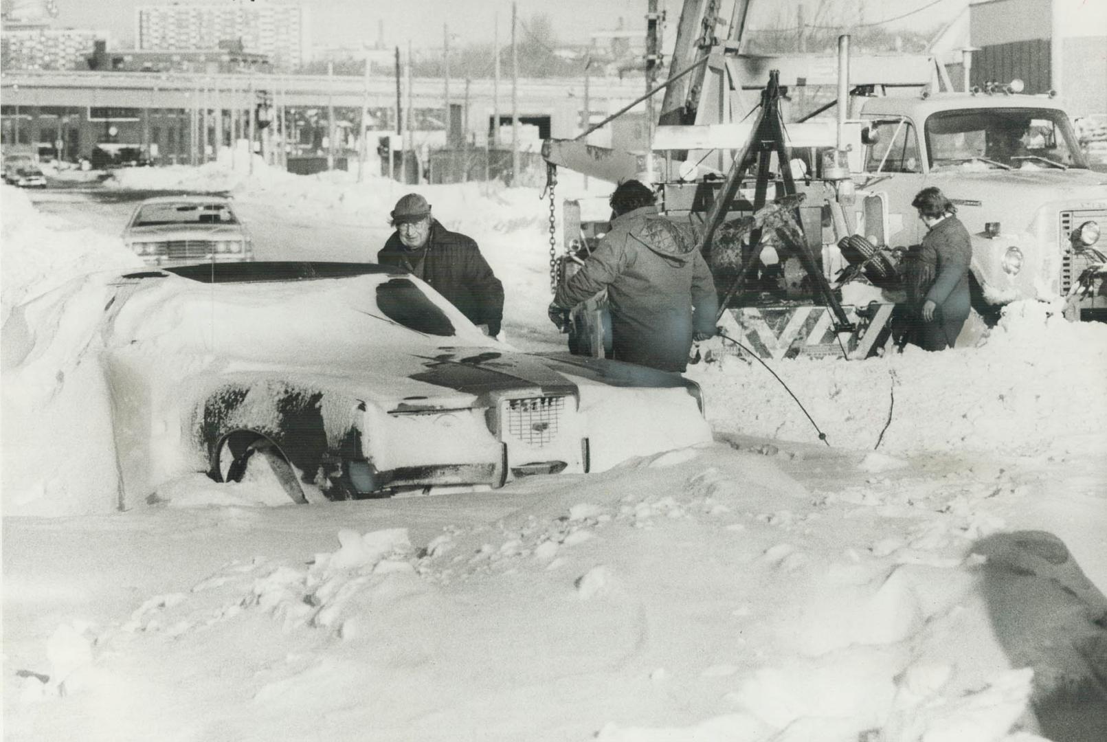 Stationary engineer Norman Little (left), 67, of East York, braved blizzard yesterday to drive to job at Shell Oil plant on Commissioner St. But blowi(...)