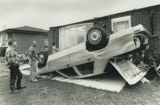 Filippo D'Anniba and his wife Angel check damage in southwest Woodstock