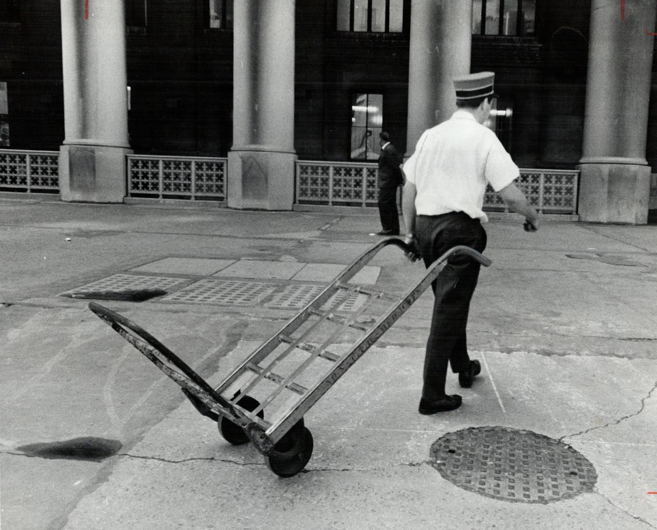 Empty luggage cart at strike-bound union station symbolizes plight of campers