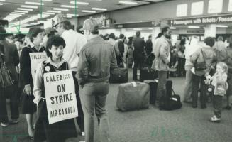 Message clear: One of the striking ticket agents demonstrates inside the airport