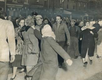 Angry women picket pulls the hair of a worker of the same sex outside the Hamilton Cotton plant today as tempers reached a new high in the second day (...)