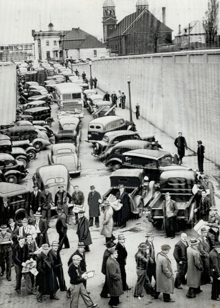 These pickets at Windsor made mild protest when fellow-strikers first started to move the tangled mass of vehicles blockading this street but the union order prevailed