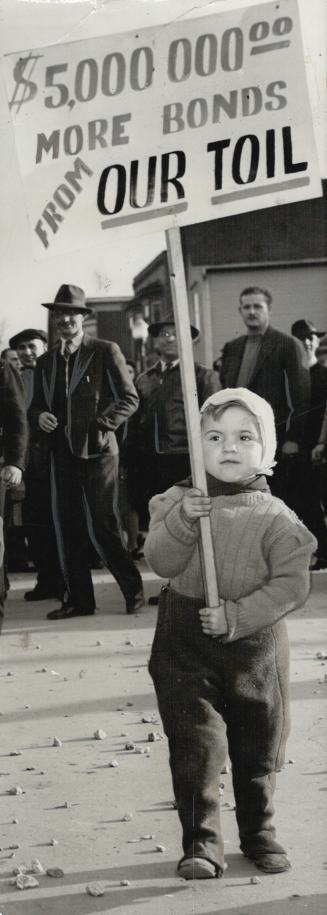 Tiny picketer at the Ford plant in Windsor is Ernie Torau, thre whose father is a striker