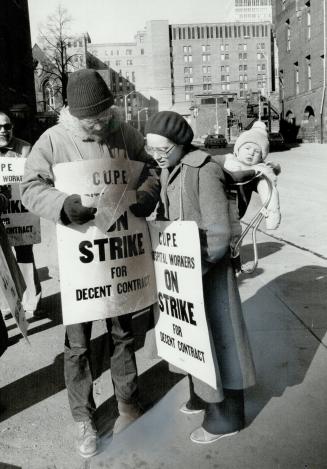 Onlooker: Peter McCombie, 6 months, watches as mother Sandy pickets outside Toronto General Hospital