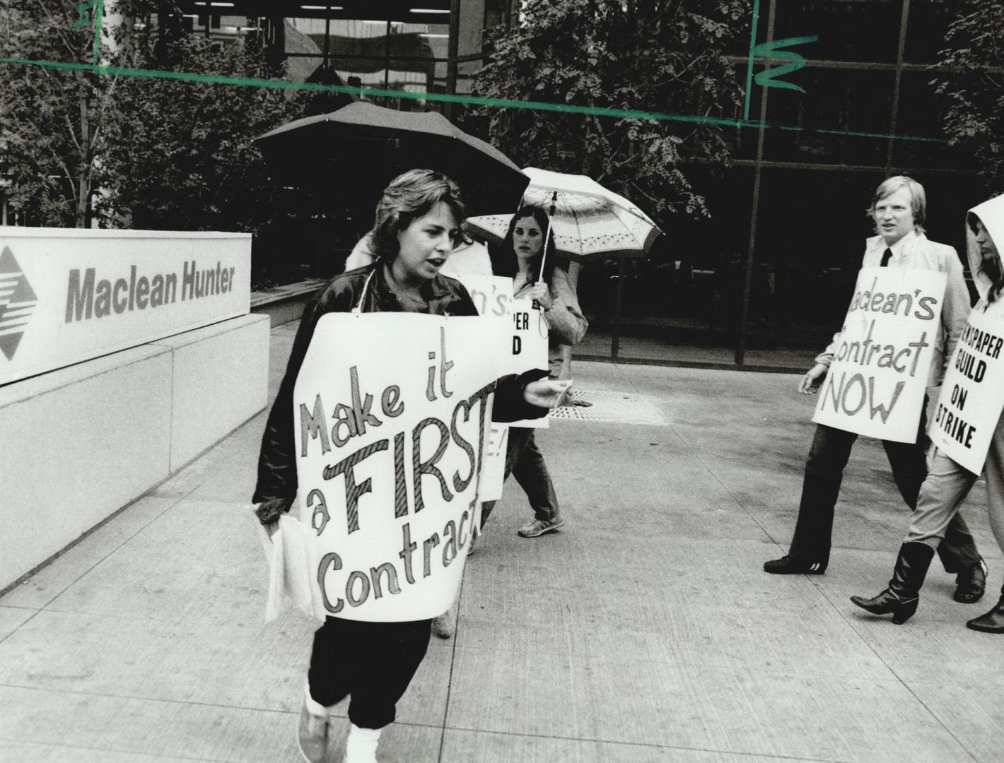 Striking in the rain, Maclean's magazine editorial workers picketed their employer's offices on College St