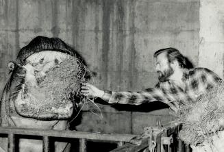 Day Three: Zoo manager Calvin White (right) feeds hippopotamus while about 40 strikers (above) meet at makeshift headquarters