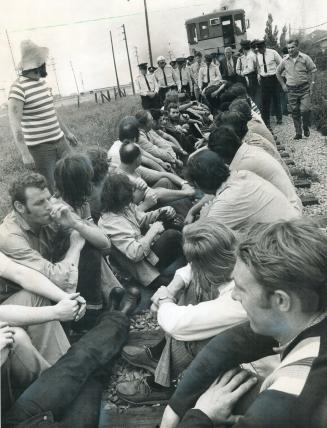 Union members sit defiantly on the train tracks in front of the Pilkington Glass Ltd