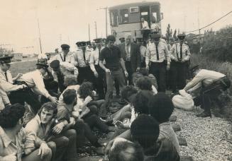 Metro police drag strikers from path of a 9-car Canadian National freight train trying to deliver supplies to strikebound Pilkington Glass Ltd. plant (...)