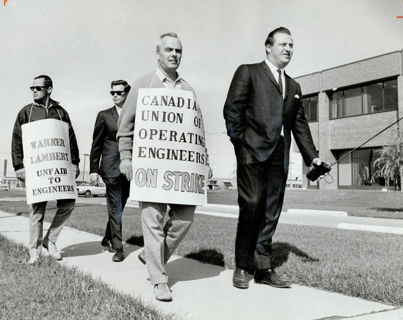 Two powerhouse men strike 950-employee drug house, Paul Taylor (left), local president Vince McManus, striker William McLaughlin, union's Robert Souliere on line