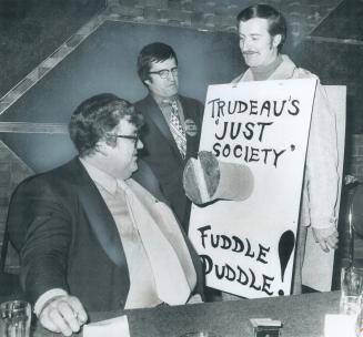 Head of teachers' negotiating team, Dough Dinsmore (seated), talks to striking high school teacher Raymond Auger at meeting of more than 1,500 Etobico(...)