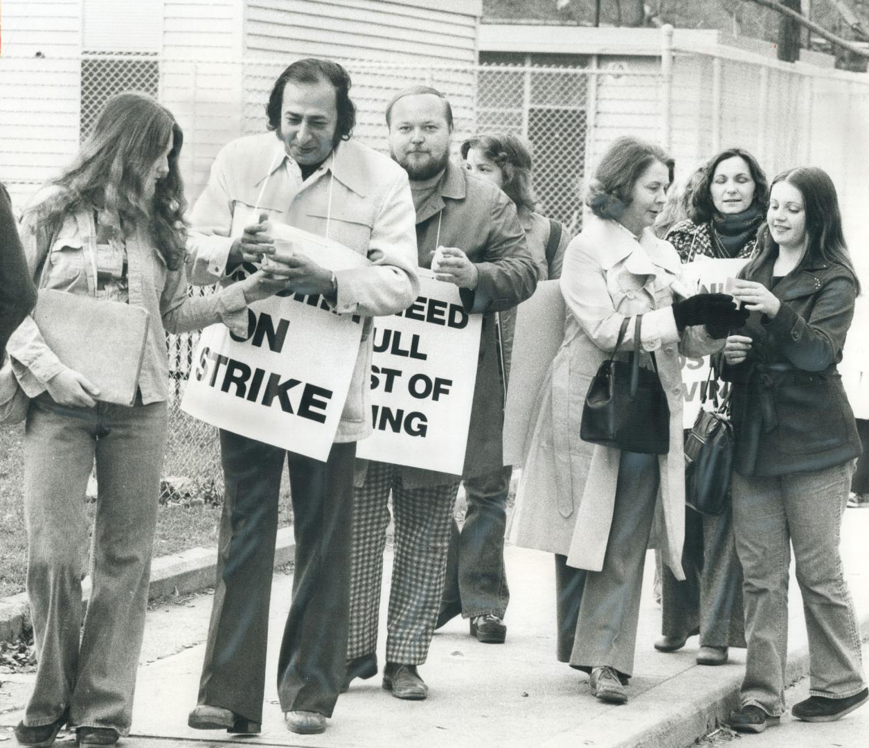 Before crossing a picket line of striking students at Eastern High School of Commerce give the teachers coffee today