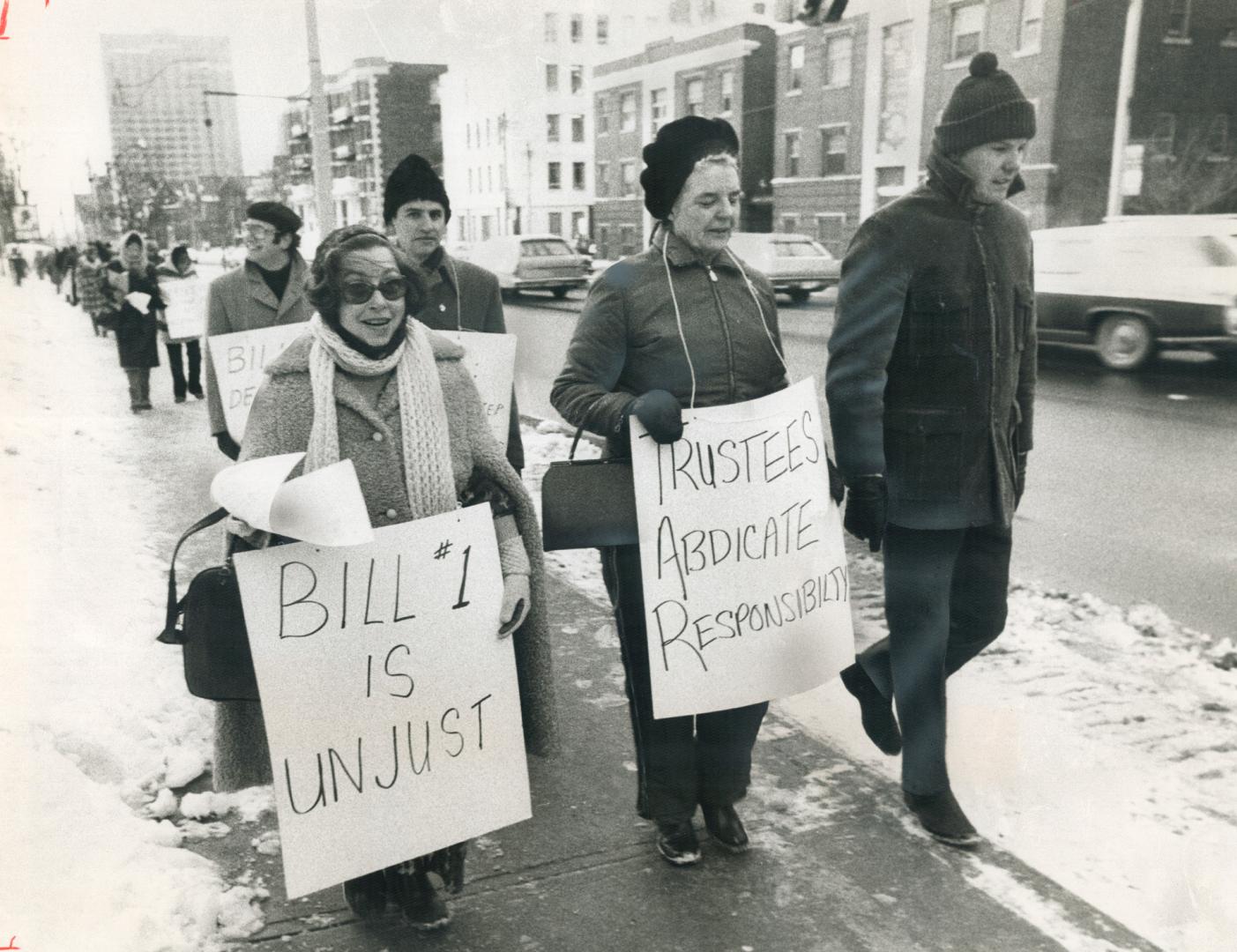 Still on strike mentally, as one teacher says, some of the 8,800 striking teachers legislated back to work form protest lines outside Jarvis Collegiat(...)