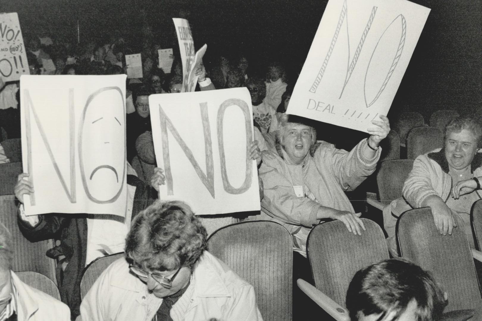 'No' signs, A small, vocal group of teachers hold up signs at Massey Hall last night to show their disapproval of the tentative agreement reached with(...)