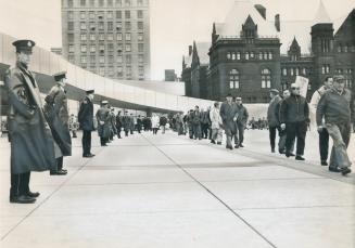 Peaceful confrontation: police and metro strikers maintain an orderly vigil in Nathan Phillips Square, The new City Hall is at far left, Police are lined up between it and the marching pickets