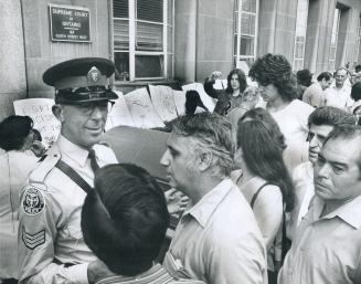 Talking to police sergeant, Patrick Murphy, president of striking Canadian Union of General Employees (CUGE), and strikers from Toronto Western Hospit(...)