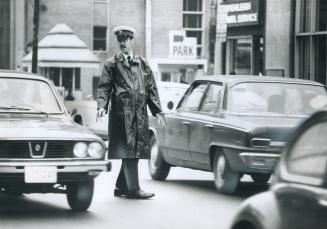 On the first day of the TTC strike, PC Brian Burnett is stormed by cars from all directions as he stands on duty directing traffic during morning rush(...)