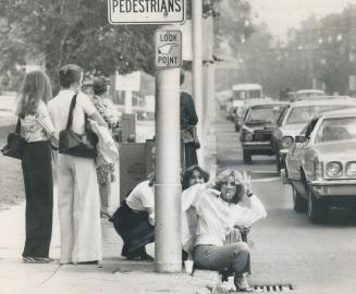 A Frustrated commuter shows her feelings about Metro's transit strike as she sits at a curb by Mt