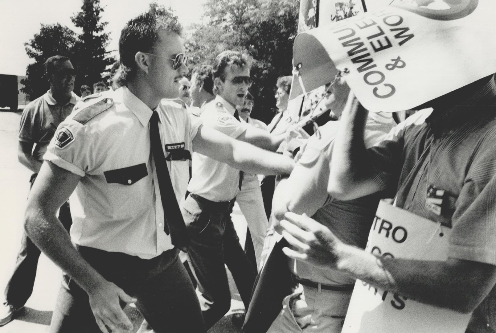 Nasty confrontation: Security guards turn back Bell Canada strikers and locked-out CFTO workers who tried to enter the Scarborough television station's property yesterday