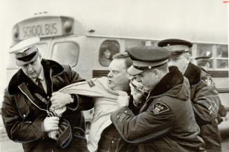 Police Grab Unionist George Ingham, during picket line violence outside Chelmsford District Composite School in Sudbury area. Steelworker Ingham. secr(...)