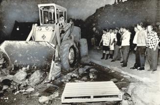 Earth-Removal Equipment hired by steelworkers union pushes away rocks and debris set up by strikers at the Copper Cliff smelter of the International N(...)